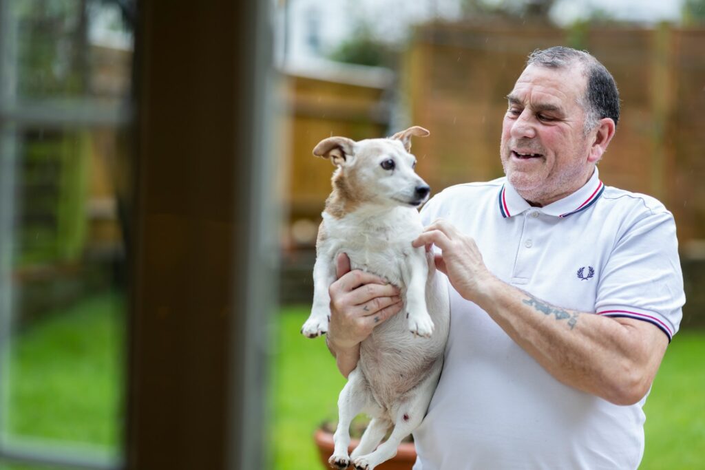 Old man holding a dog