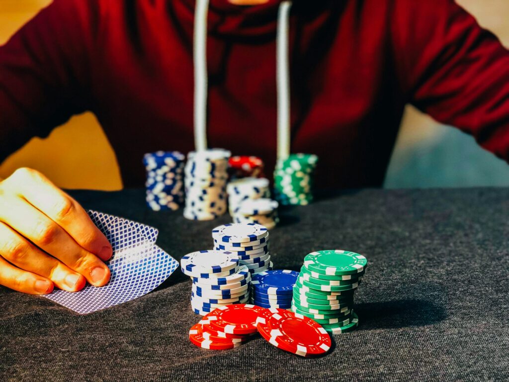 Close up of a man sitting at a betting table with poker chips